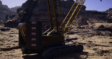 CGI Heavy machinery operates on rugged terrain in remote landscape video