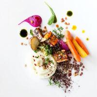 A plate with vegetables and meat on it photo
