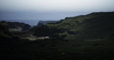 CGI Misty landscape view of rocky cliffs near the ocean at dusk video