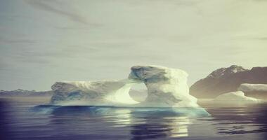 CGI Majestic ice arch rises above calm waters in remote arctic landscape video