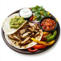 A plate with chicken, peppers, and salsa photo