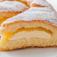 A pastry with a slice missing on a plate photo