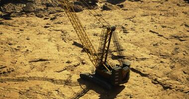 CGI Heavy machinery operates on rugged terrain during daylight hours video
