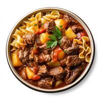 Beef stew with pasta and vegetables in a bowl on a white background photo