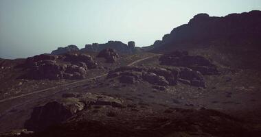 CGI Sunset over rocky landscape in a remote mountainous area of nature video