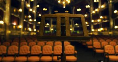 CGI Elegant theater with lit chandeliers and empty seats awaiting guests video