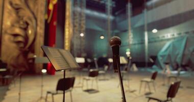CGI Empty stage with microphone and chairs awaiting the performance at evening video