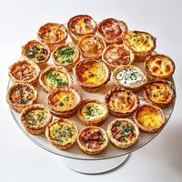 A plate of mini quiches on a white background photo