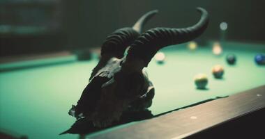 CGI Unique pool table setup with ram skull and colorful balls in dim light video