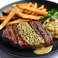 Grilled steak with a side of mashed potatoes photo