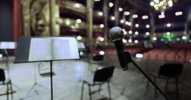 CGI Empty theater stage with microphone ready for performance and chairs arranged video