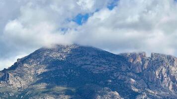 This scenic view of a majestic mountain peak is partly obscured by clouds, showcasing natures splendor photo