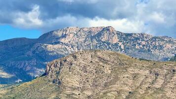 The breathtaking view of a stunning mountain range showcases vibrant skies paired with rugged terrain photo