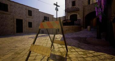 CGI Construction barrier blocks pathway in village street during sunny day video