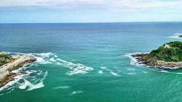 Experience stunning and breathtaking coastal views that showcase the beautiful turquoise waters and gentle waves photo