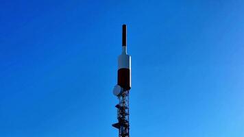 A cell tower with a large antenna on top photo