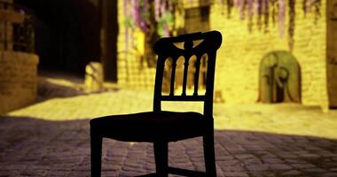 CGI Charming empty chair on cobblestone street illuminated by golden light video