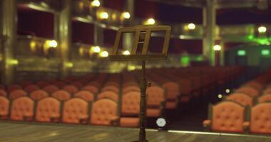 CGI Empty theater stage awaits performance with illuminated seating area video