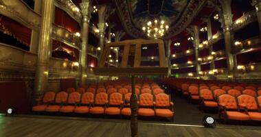 CGI Empty theater stage with music stand and audience seating during performance video