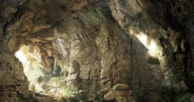 CGI Stunning natural cave with sunlight illuminating rocky formations and greenery video