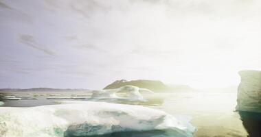 CGI Ice formations and reflective water create serene landscape at sunrise video