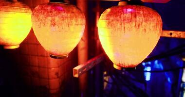 CGI Beautiful illuminated lanterns hanging in a vibrant nightlife district video