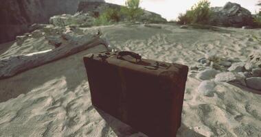 CGI Old suitcase left on sandy beach in a remote location during sunset video