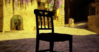 CGI Silhouetted chair on cobblestone street illuminated by warm evening light video