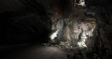 CGI Exploring a dark cave with dramatic lighting and intriguing rock formations video