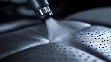 Extreme Close-Up of a Vacuum Nozzle Removing Dust from Car Seat Crevices photo