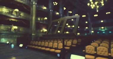 CGI Concert hall with empty seats and music stand in focus during evening event video
