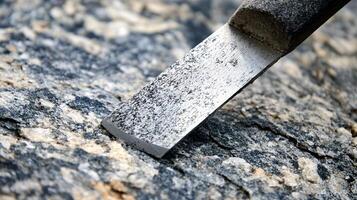 Skilled Artisan Shaping Raw Granite with a Precision Stone Chisel photo