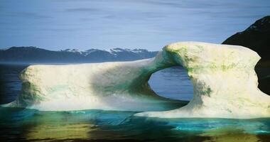 CGI Unique ice arch formation in a tranquil glacial body of water during daylight video