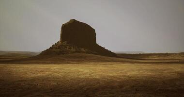 CGI Massive rock formation rises from barren landscape under muted sky video
