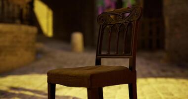 CGI Old wooden chair placed on cobblestone street near historic building at sunset video