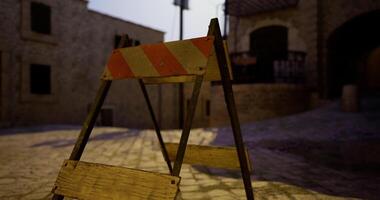 CGI Traffic barrier stands in a quiet cobblestone street at dusk video