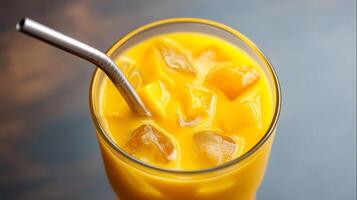 Enjoy a delicious mango drink filled with ice, perfect for quenching thirst on a hot summer day. Ideal for cooling off while lounging by the poolside. photo