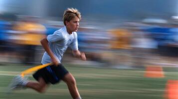 A young boy swiftly spins to avoid a defender during a flag football game at a sports field, showcasing agility and skill while the sun shines brightly. photo