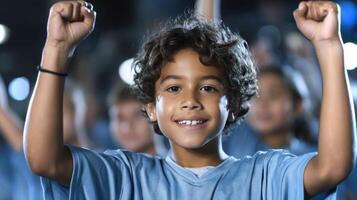 A joyful mixed-race boy celebrates with his fists raised high, surrounded by a cheering crowd under night lights, expressing excitement and unity. photo