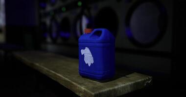 CGI Blue container on a wooden table in a dimly lit laundromat at night video