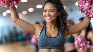 A mixed-race girl showcases her talents with a solo cheerleading routine using pom-poms in an energetic gym setting. Her excitement is palpable as she performs. photo