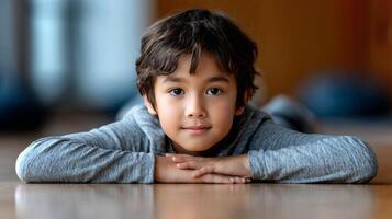 A Latino boy is engaged in yoga, performing the pigeon pose with his arms stretched out, showing focus and determination in a serene indoor environment. photo