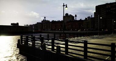 CGI Evening waterfront view with city skyline and illuminated lampposts video