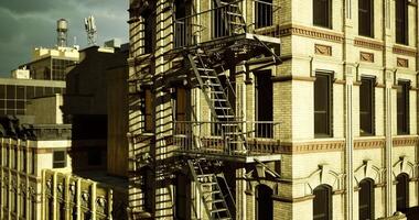 CGI Urban building with fire escape against cloudy sky in late afternoon video
