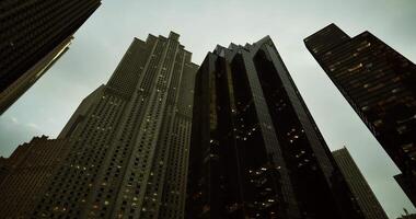 CGI Tall modern buildings under cloudy sky in urban landscape at dusk video