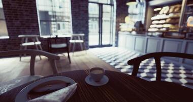 CGI A cozy cafe features a wooden table with a small cup of coffee and a dessert video