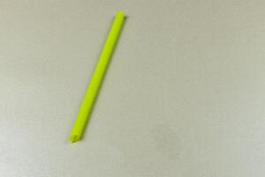 Bright yellow straw placed on a light surface in a kitchen photo