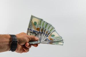 Hand holding cash in denominations of one hundred dollars photo