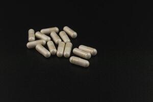 Natural health supplements arranged on a dark surface photo