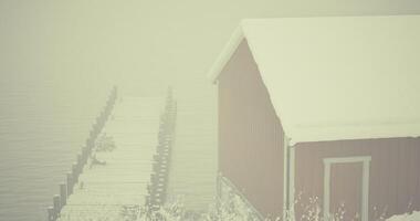 CGI Snowy shoreline cabin with pier and foggy atmosphere in winter setting video